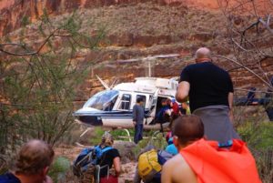 Group of people watching Aaron get into the rescue helicopter in the Grand Canyon